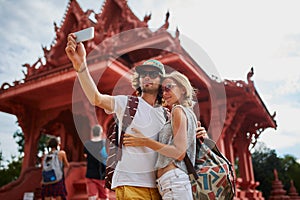 Tourists taking photos at temple on koh samui thailand