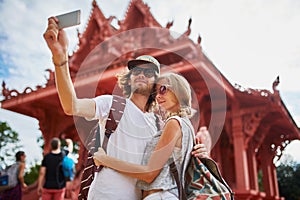 Tourists taking photos at temple on koh samui thailand