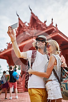 Tourists taking photos at temple on koh samui thailand