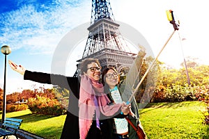 Tourists taking selfie against the Eiffel Tower