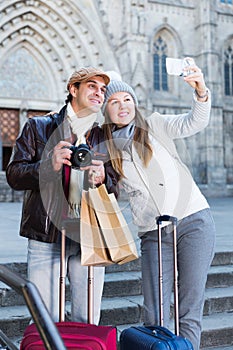 tourists taking selfie on mobile phone