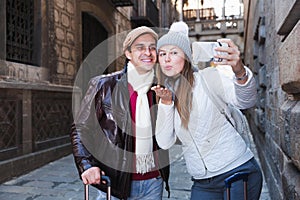 tourists taking selfie on mobile phone