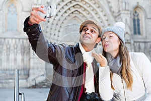 tourists taking selfie on mobile phone