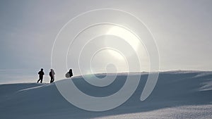 Tourists teamwork, climbing the mountain, helping each other, reaching the top. Overcoming difficulties, helping hand.