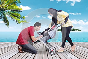 Tourists with their baby on the jetty