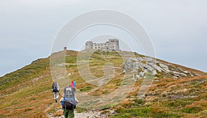 Tourists on the trail in the mountains. Panoramic view of the rocky mountains of the Carpathians, Ukraine