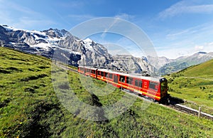 Tourists traveling on a cogwheel train of the famous Jungfrau Railway from Jungfraujoch Top of Europe photo