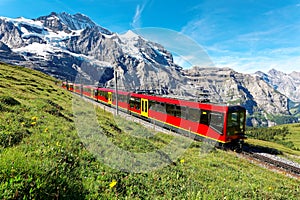 Tourists traveling on a cogwheel train of the famous Jungfrau Railway from Jungfraujoch Top of Europe