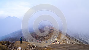 Tourists trekking in the foggy mountains on the way to Kawa Ijien sunrise