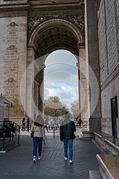 Tourists underneath the Arc de Triomphe on a spring morning in Paris, France