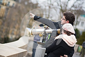 Tourists using telescope for sightseeing