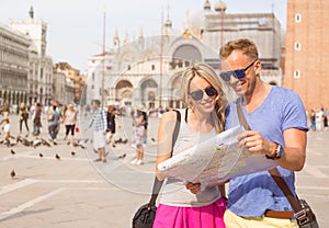 Tourists in Venice looking at city map