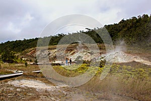 Tourists view the Sulphur banks that can be found walking along the boardwalk in Volcanoes National Park