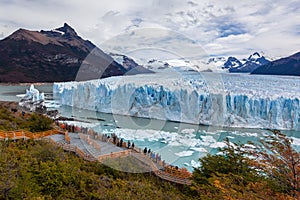 Tourists at viewpoint. Perito Moreno glacier frozen ice field.