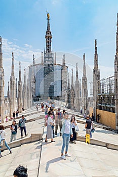 Tourists visit the roof of Milan Cathedral Duomo di Milano in summer time.