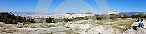 Tourists visiting the Acropolis and Athens city panorama