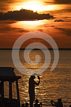 Tourists visiting the Amazon photographing the sunset in Alter do ChÃÂ£o-SantarÃÂ©m-Par photo