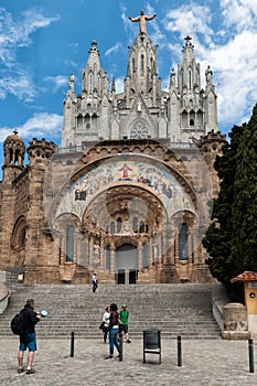 Tourists are visiting famous Temple of Sacred Heart of Jesus Expiatori del Sagrat Cor on Tibidabo mountain in Barcelona, Catalo