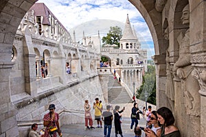 Tourists are visiting the Fisherman`s Bastion or Halaszbastya on the Castle Hill in Budapest, Hungary