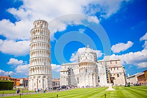 Tourists visiting the leaning tower of Pisa , Italy