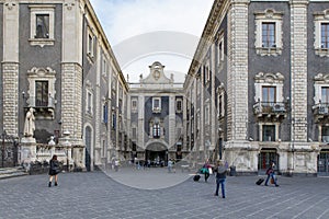 Tourists visiting the Piazza del Duomo and Porta Uzeda