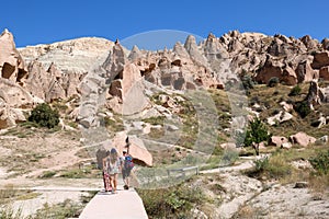 Tourists visiting zelve open air museum, archaeological site in cappadocia