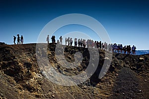 Tourists on the volcanic island named Nea Kameni.