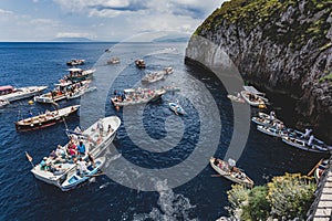 Tourists waiting on the boat outside the entrance to blue Grotto a sea cave on the coast of the island of Capri in southern Italy