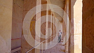 Tourists walk through a corridor of Hatshepsut