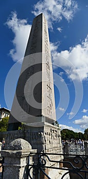 Tourists walk by the Egyptian obelisk in  Hippodrome