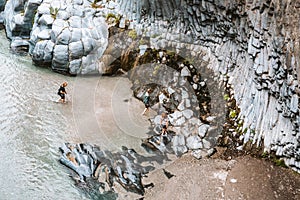 Tourists walking in Alcantara Gorge and Alcantara river park in Sicily Island, Italy. Gole Alcantara Botanical and Geological Park