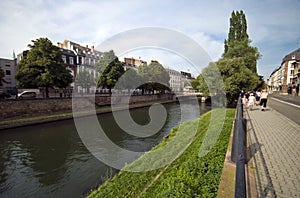 Tourists walking along a river in Strasbourg