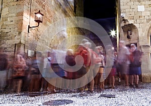 Tourists walking along the stores of famous Socrates street at the old medieval town of Rhodes, one of the best