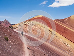 Tourists walking down the Red Valley (valle rojo) after visiting the Rainbow Mountain, Cusco region, Peru