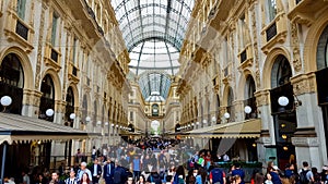 Tourists walking in Galleria Vittorio Emanuele, Milan luxury shopping, fashion