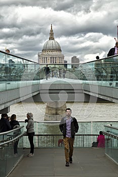 Tourists walking on milenium bridge in London