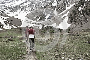 Tourists walking in the mountains in the tianshan highlands in search of missing people