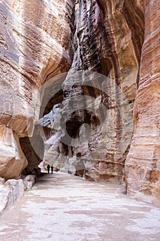 Tourists walking in Petra gorge at very cold winter day