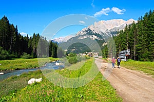 Tourists walking scenic path in Dolomites