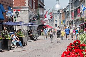 Tourists walking on St Paul Street and visiting Old Montreal in Summer