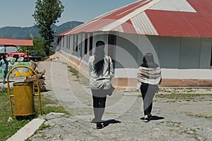 Tourists walking through the streets of Shogran, Pakistan, enjoying the scenery