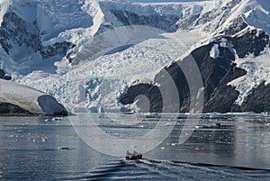 Tourists watching a glacier in Antarctica,