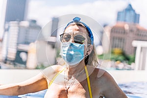 Tourists wear the protective mask in the pool to protect themselves from the coronavirus