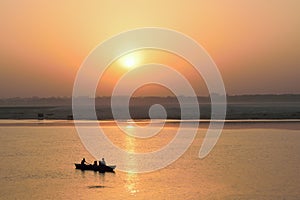 Tourists on wooden boats at Ganges river in Varanasi, India