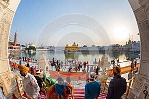 Tourists and worshipper walking inside the Golden Temple complex at Amritsar, Punjab, India, the most sacred icon and worship plac