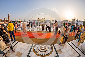 Tourists and worshipper walking inside the Golden Temple complex at Amritsar, Punjab, India, the most sacred icon and worship plac