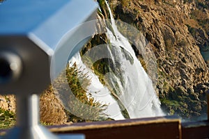 Touristy binoculars and a waterfall photo
