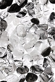 Tourmalinated quartz heap stones texture on white light background