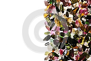 Tourmaline heap stones texture on half white light isolated background. Place for text