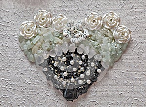 Tourmaline, quart and aquamarine crystals heart shape closeup on elegant white